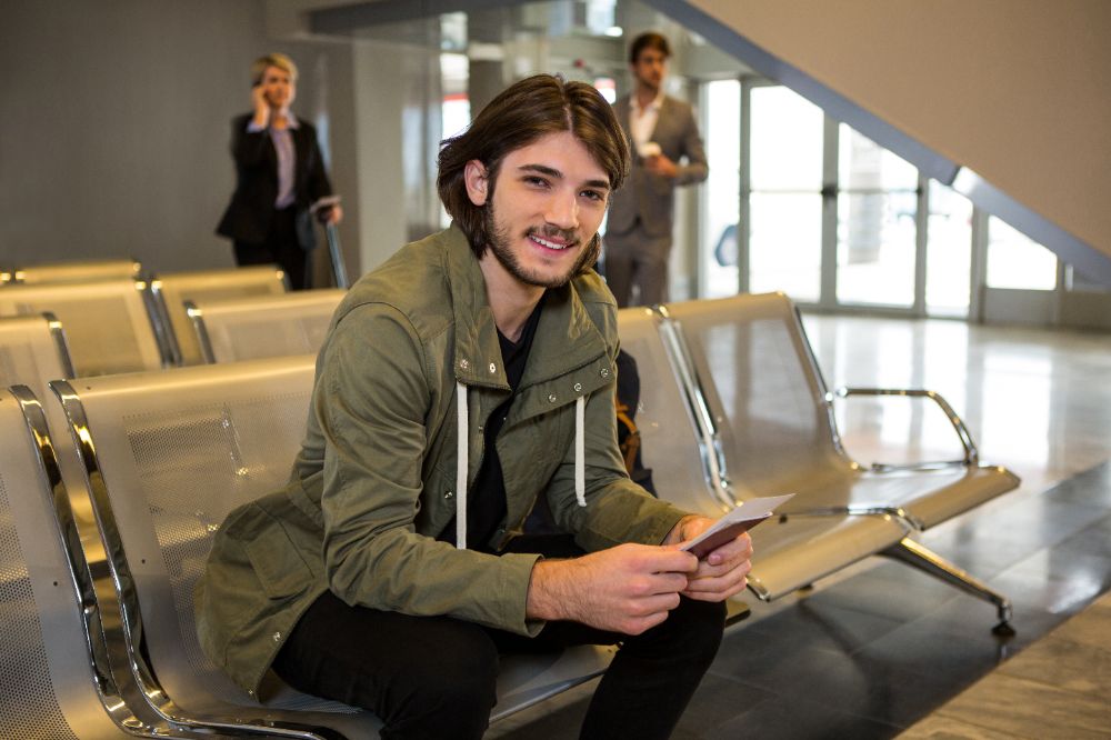 Happy Passenger Sitting in Waiting Area